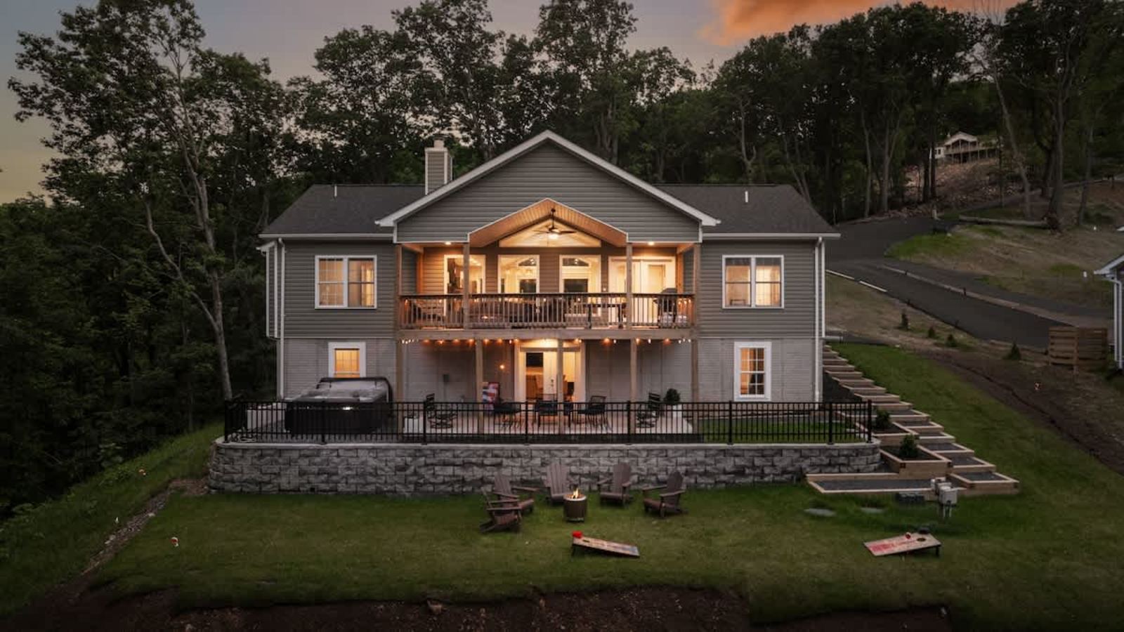 Aerial view at sunset of the house set against the wooded ridge