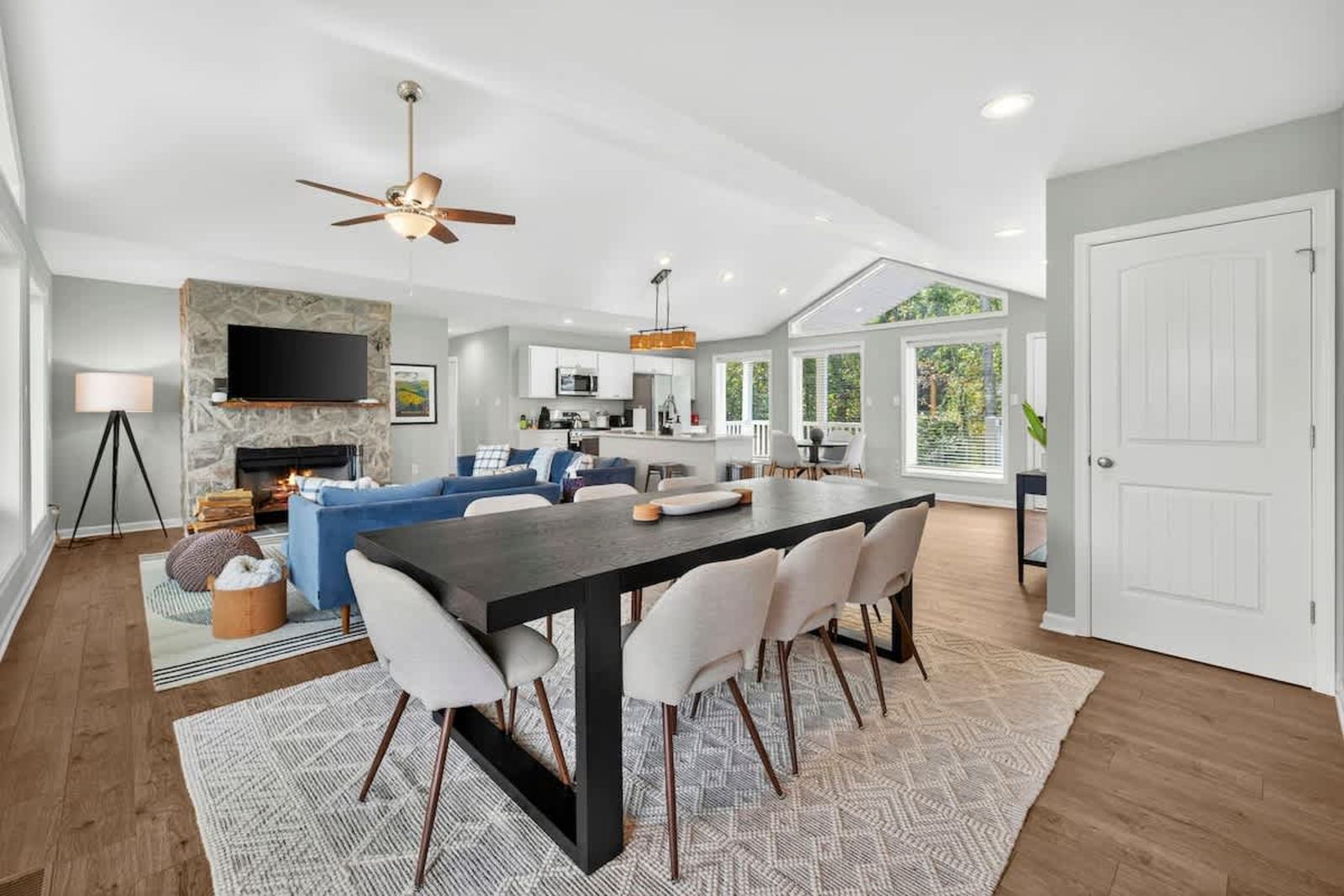 Dining table for eight beside the stone fireplace